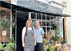  ??  ?? Florists Wendy and Mark Rowley. Above, some of the social distancing barriers