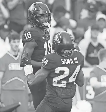  ?? NIRMALENDU MAJUMDAR/AMES TRIBUNE ?? Iowa State wide receiver Daniel Jackson (16) celebrates with running back Abu Sama after a third-quarter touchdown during Saturday's victory over Oklahoma State in Ames.
