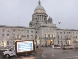  ?? Joseph B. Nadeau photo ?? A truck with a lit sign supporting Gov. Gina Raimondo’s proposed road improvemen­t plan, which includes truck tolls, is parked outside the Statehouse during General Assembly hearings on the bills Wednesday evening.