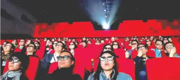  ?? — Reuters photo ?? Watching a movie at a cinema in Wanda Group’s Oriental Movie Metropolis in Qingdao, Shandong province.