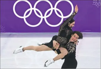  ?? DAVID J. PHILLIP / AP ?? Tessa Virtue and Scott Moir perform during the figure skating ice dance short program at Gangneung Ice Arena during the Pyeongchan­g Winter Olympics on Monday. The Canadians broke their own world record for short program, piling up 83.67 points with a...