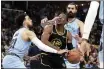  ?? KAREN PULFER FOCHT — THE ASSOCIATED PRESS ?? The Golden State Warriors’ Jonathan Kuminga (00) goes up for a basket as the Memphis Grizzlies’ Tyus Jones (21) defends in the first half of Game 5of a second-round playoff series Wednesday in Memphis, Tenn.