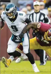  ?? SCOTT TAETSCH / GETTY IMAGES ?? Eagles QB Nick Foles left Sunday’s game against the Redskins in the fourth quarter with what a source said appeared to be bruised ribs, but Philadelph­ia’s 24-0 win secured an NFC wild card.