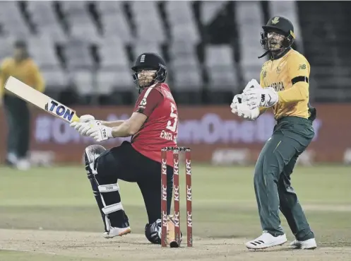  ??  ?? 0 England’s Jonny Bairstow hits out as South Africa wicketkeep­er Quinton de Kock looks on during the first T20 in Cape Town.