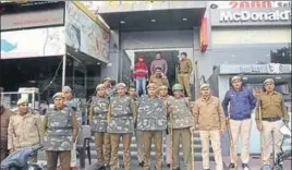  ?? MANOJ DHAKA/HT ?? Police personnel stand guard outside a cinema hall in Rohtak on Wednesday.