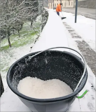  ?? [ISTOCK PHOTO] ?? In addition to spreading de-icing products, most of the time snow removal is required to keep sidewalks safe.