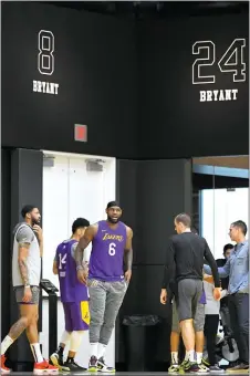  ?? MARK J. TERRILL — THE ASSOCIATED PRESS ?? The Lakers’ Anthony Davis, left, stands with LeBron James as Kobe Bryant’s numbers are displayed at the team’s practice facility on Wednesday in El Segundo, Ca;if.