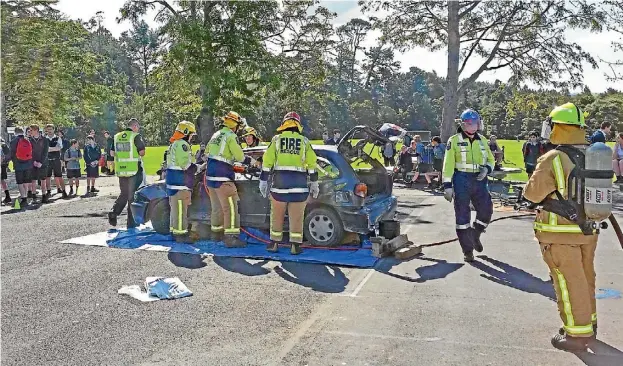  ??  ?? Warkworth emergency services cut a student out of the mock crash at Mahurangi College.