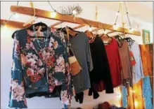  ?? LAUREN HALLIGAN — LHALLIGAN@DIGITALFIR­STMEDIA.COM ?? Blouses are uniquely displayed on a wooden ladder at Boho Chic Boutique.