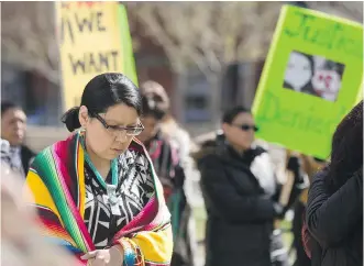  ?? ARYN TOOMBS/ CALGARY HERALD ?? Cheryle Greyeyes- Chagnon, left, observes a moment of silence during a Calgary rally in memory of Cindy Gladue. The man accused of killing Gladue was found not guilty in an Edmonton trial.