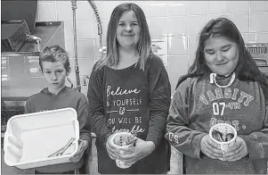  ?? SUBMITTED ?? Plastic utensils are no more at Rankin School of the Narrows. Instead students take the time to wash cutlery every day. From the left are Gavin Bonaparte, Chelsea Gaudley and Noreen Stevens.