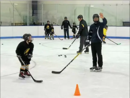  ?? SUBMITTED PHOTO ?? Members of the Hill School ice hockey team skate with young players in the Pottstown Penguins program. Hill Hockey Helps, a philanthro­pic organizati­on created by Hill senior Vincent Petrone, is lending its support to the Penguins and Pottstown PAL throughout the year with clinics and fundraisin­g.