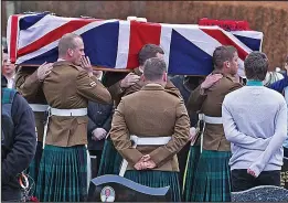  ??  ?? Grieving comrades: Fellow soldiers carry the coffin to the grave