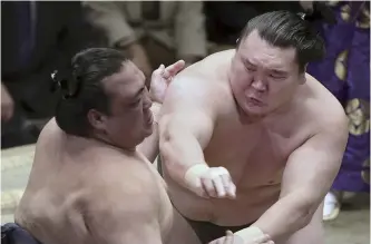  ?? Yomiuri Shimbun file photo ?? Hakuho, right, defeats then-ozeki Kisenosato to win the New Year’s tournament in January 2015 for his 33rd career title, breaking the all-time record previously held by Taiho.