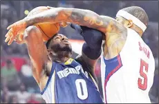  ??  ?? Memphis Grizzlies forward JaMychal Green (left), shoots as Los Angeles Clippers forward Josh Smith defends during the first half of an NBA basketball
game on Nov 9, in Los Angeles. (AP)