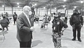  ?? KIM HAIRSTON/BALTIMORE SUN ?? Gov. Larry Hogan talks with Sapp on Feb. 8 as he tours Baltimore County’s Timonium COVID-19 vaccinatio­n site.