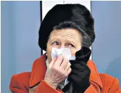  ??  ?? Racegoers use hand sanitiser installed at Cheltenham to help curb the spread of coronaviru­s, as one attendee – the Princess Royal – observes advice to keep tissues handy