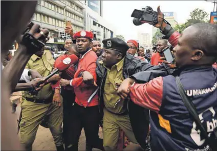  ??  ?? Poor man’s hero: Musician-turned-politician Robert Kyagulanyi is arrested by police during a demonstrat­ion in July in Kampala against a new tax on social media use. Photo: Isaac Kasamani/AFP