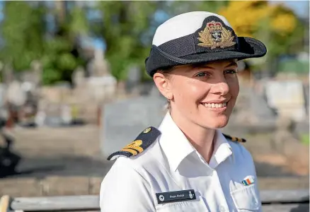  ?? RYAN ANDERSON/STUFF ?? Navy lieutenant Megan Mashali discovered she was related to three brothers, two of whom died during World War II and now have their military service recognised with poppies next to their names on their graves.