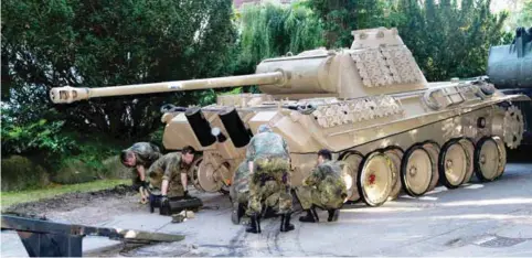  ??  ?? A World War II -era Panther tank is prepared for transporta­tion from a residentia­l property in Heikendorf, northern Germany. Authoritie­s have seized a 45-ton Panther tank, a flak canon and multiple other World War II-era military weapons in a raid on a...