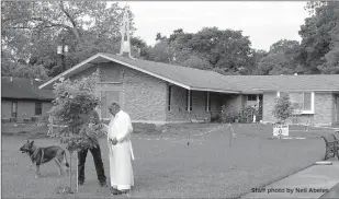  ?? Staff photo by Neil Abeles ?? ABOVE: The Rev. Dan Gonzalez, pastor of St. Catherine of Sienna Catholic Church in Atlanta, talks with Roger Opiela of Jefferson, Texas, about the tree he planted in honor of his relatives. The church’s initial work on its new gathering hall is seen in...