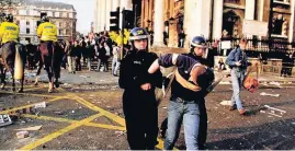  ??  ?? FLASHPOINT a protester is led away during one of the many anti-poll tax demos