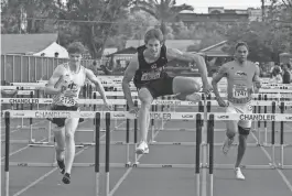  ?? SAM BALLESTERO­S/THE REPUBLIC ?? Gilbert’s Vance Nilsson, center, shown at a Chandler meet in March, broke the state 300-meter hurdles record on Friday in Mesa.