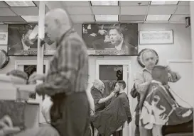  ?? Pablo Martinez Monsivais / Associated Press ?? Everyone in Washington, D.C., including the barbershop Puglisi Hair Cuts, seemed to tune in to the televised coverage of former FBI Director James Comey testifying.