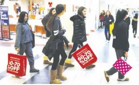  ??  ?? People shop during the Black Friday sales shopping event at Roosevelt Field Mall in Garden City, New York, U.S., November 23, 2018.