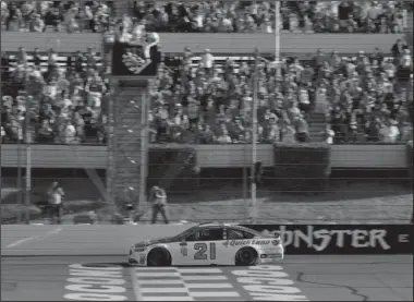  ?? The Associated Press ?? BLANEY’S FIRST WIN: Ryan Blaney takes the checkered flag to win the NASCAR Cup Series Pocono 400 auto race Sunda in Long Pond, Pa.