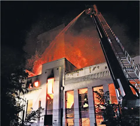  ??  ?? Firefighte­rs tackling a huge fire that broke out at Liverpool’s Littlewood­s Pools building on Sunday. It is thought that the Thirties art deco facade has withstood the flames