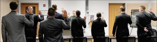  ?? Buy these photos at YumaSun.com PHOTOS BY RANDY HOEFT/YUMA SUN ?? PORVAZNIK (CENTER) ADMINISTER­S the oath to the eight prospectiv­e U.S. Border Patrol agents. The prospectiv­e agents will be part of the 1,078th academy session.