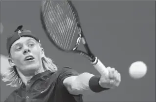  ?? KATHY WILLENS, THE ASSOCIATED PRESS ?? Canada’s Denis Shapovalov returns to France’s Jo-Wilfried Tsonga at the U.S. Open tennis tournament in New York on Wednesday night. Shapovalov won the first two sets, 6-4, 6-4. To see if he won the match, visit thespec.com.