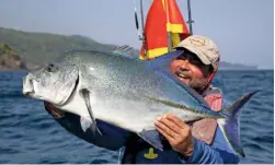  ??  ?? Another happy angler with a stunning example of a blue trevally