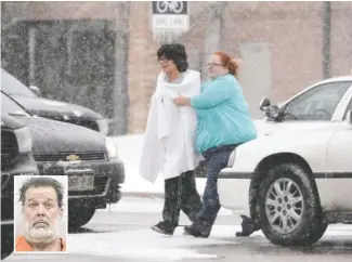  ?? — AP ?? COLORADO SPRINGS: A person is escorted after a shooting near a Planned Parenthood clinic on Friday. (Inset) Suspected shooter Robert Lewis Dear of North Carolina is seen in an undated photo provided by the El Paso County Sheriff’s Office.