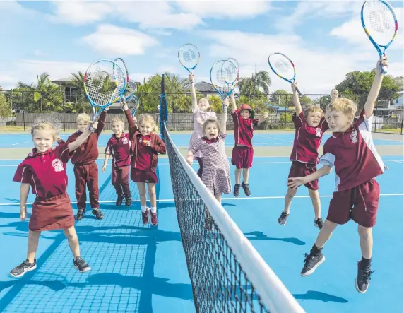  ?? Picture: TENNIS AUSTRALIA ?? Students from Burleigh Heads State School try out the new racquets that have been supplied as part of the Tennis Hot Shots initiative.