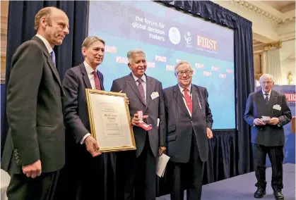  ??  ?? Merrill J. Fernando (centre) with other dignitarie­s on stage showing the award.