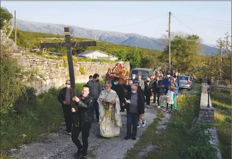  ?? (AP/Thanassis Stavrakis) ?? Faithful follow the procession of Jesus’ funeral bier, known as the “Epitaph” in Greek, on Friday at Agios Georgios church in Myrodafni village, Epirus region, northweste­rn Greece.