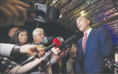  ?? CP PHOTO ?? Finance Minister Bill Morneau speaks with reporters following a meeting at the Assembly of First Nations annual general meeting in Regina. The government posted a thin budgetary surplus of $83 million between April and June, the Finance Department’s...