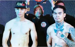  ??  ?? Dave Peñalosa, right, and Mexican Marcos Cardenas strike a pose during the weighin Friday of their fight for the vacant WBO Oriental featherwei­ght title. (Nick Giongco)