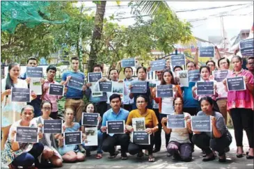  ?? SUPPLIED ?? Staffers at the Cambodian Center for Human Rights hold up signs reading ‘Save Press Freedom Cambodia’ in solidarity with the newspaper.