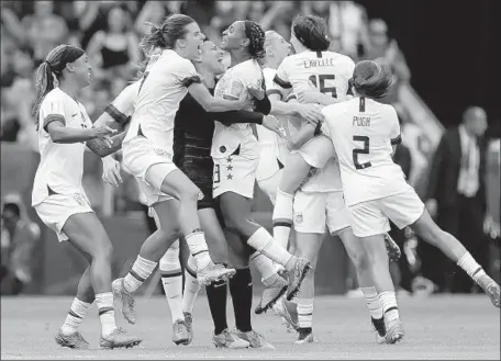  ?? Claude Paris Associated Press ?? U.S. PLAYERS celebrate beating the Netherland­s in the Women’s World Cup final Sunday before partying deep into Monday morning at a swank restaurant in Lyon, France. They are being honored with a ticker-tape parade through the streets of Manhattan on Wednesday.