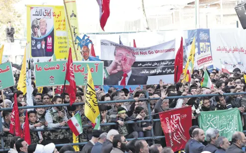  ??  ?? Iranians hold a placard showing a caricature of U.S. President Donald Trump during an anti-U.S. demonstrat­ion marking the 39th anniversar­y of the U.S. Embassy takeover in Iran, Nov. 4.