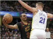  ?? TONY DEJAK — THE ASSOCIATED PRESS ?? George Hill looks to pass against the Warriors’ Jonas Jerebko during the first half Dec. 5 at Quicken Loans Arena.