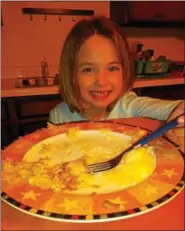  ??  ?? Author’s daughter, Kylie 7, partaking in the consumptio­n of a good luck pork and sauerkraut meal.