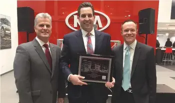  ??  ?? (Pictured l to r) Scott Fitzgerald, director Kia Central Region; Francis Mauro, co-owner Internatio­nal Kia; and William Peffer, vice president U.S. Kia sales, pose with the plaque recognizin­g the opening of the Orland Kia facility.