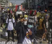  ?? THE ASSOCIATED PRESS ?? Anti-coup protesters display pictures of deposed Myanmar leader Aung San Suu Kyi in Yangon, Myanmar, on Tuesday.