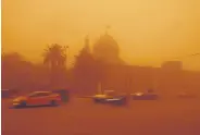  ?? ?? Cars drive by a mosque amid a sandstorm in Baghdad, Iraq, May 16, 2022.