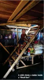  ?? ?? A child climbs a ladder inside a “Khudi Bari”.