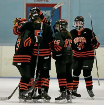  ?? MATT sTonE / hErAld sTAFF ?? LIGHTING THE LAMP: Woburn’s Lily Anderson (3), Kelsey Ficociello (5), Meaghan Keough (15) and Bella Shaw (10) celebrate a goal against Belmont on Wednesday night at Viglirolo Rink in Belmont.